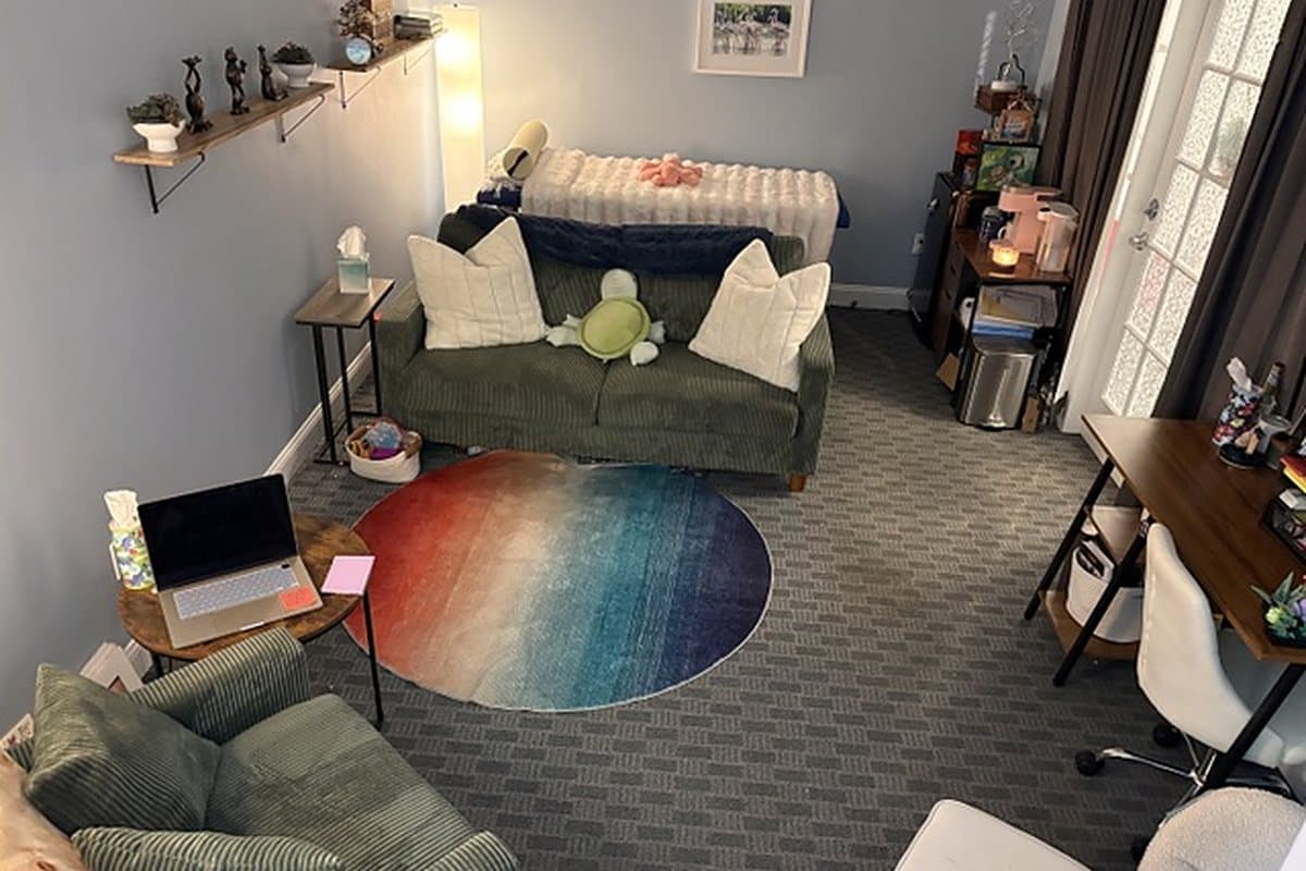 The therapy room at Ladder of Hope in Newington, CT, with a sofa, soft lighting and a warm rug